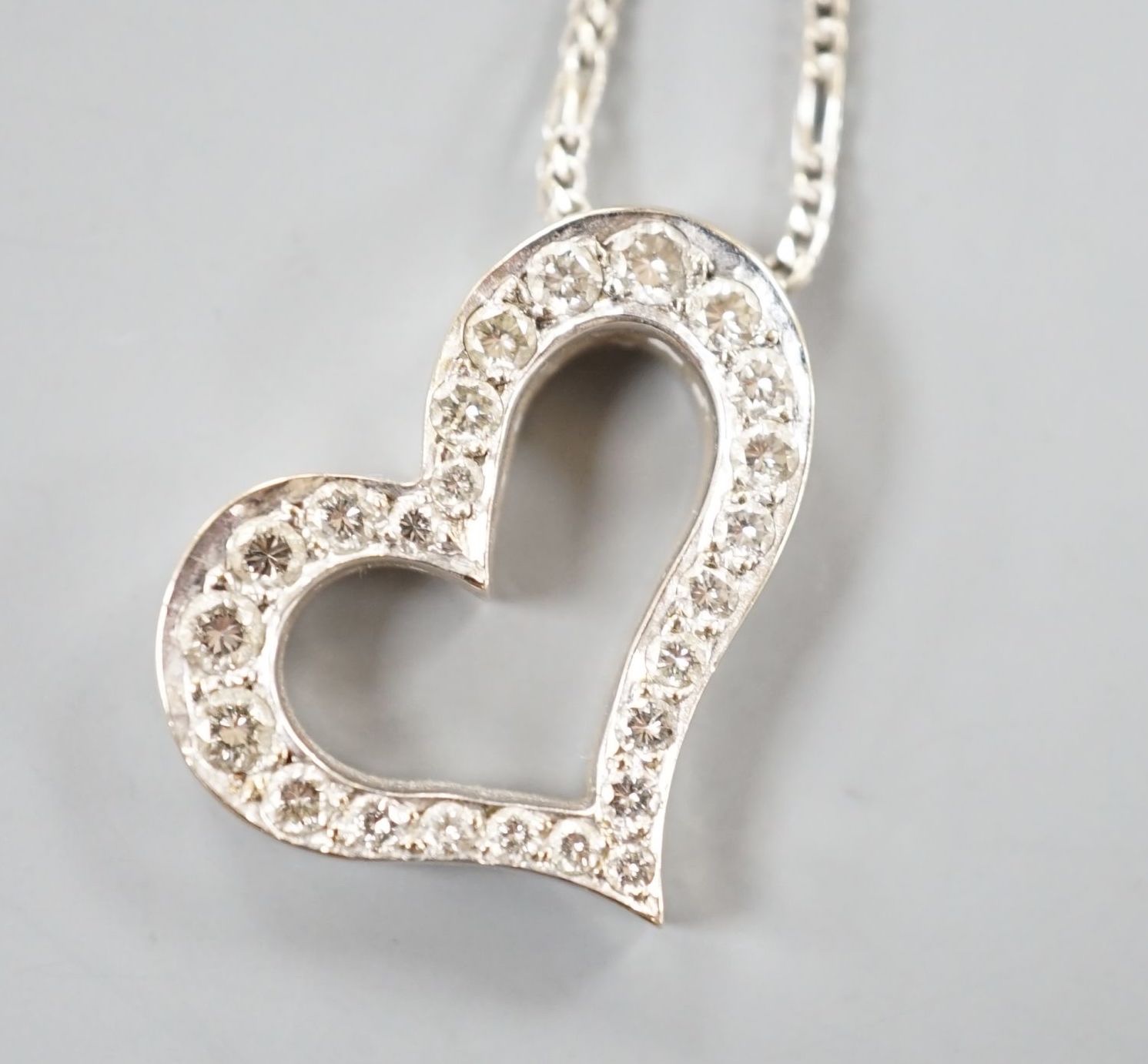 A modern 750 white metal and diamond set openwork heart pendant necklace, pendant width 22mm, chain, 40cm